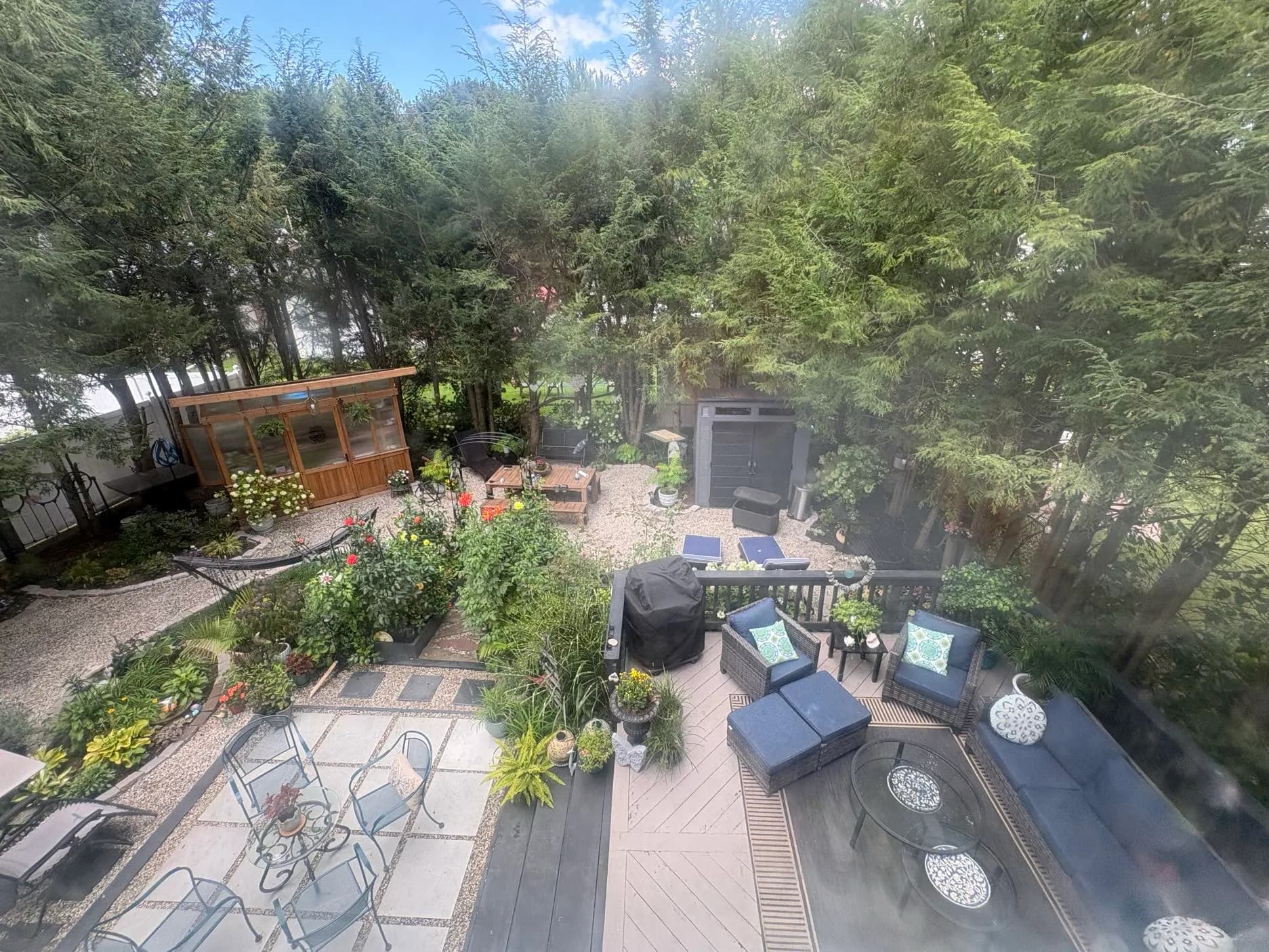 The garden from above: a patio ringed with beds and trees